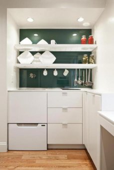 A slatted shelf unit hangs over the sink; it air-dries and stores dishes in the same spot.