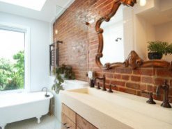 Satin-finish coated brick wall in the bathroom brings both textural beauty and a hint of glitter