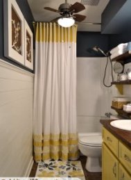 Small bathroom makeover with DIY ruffled shower curtain,  open shelves,  mosaic tile mirror,  painted floor cloth