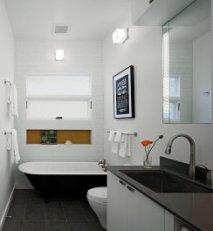 Wall sconces help in even lighting of the bathroom